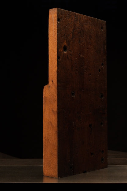 Right side profile of a heavy, two-toned historical architectural timber block featuring structural peg holes and true patina. 