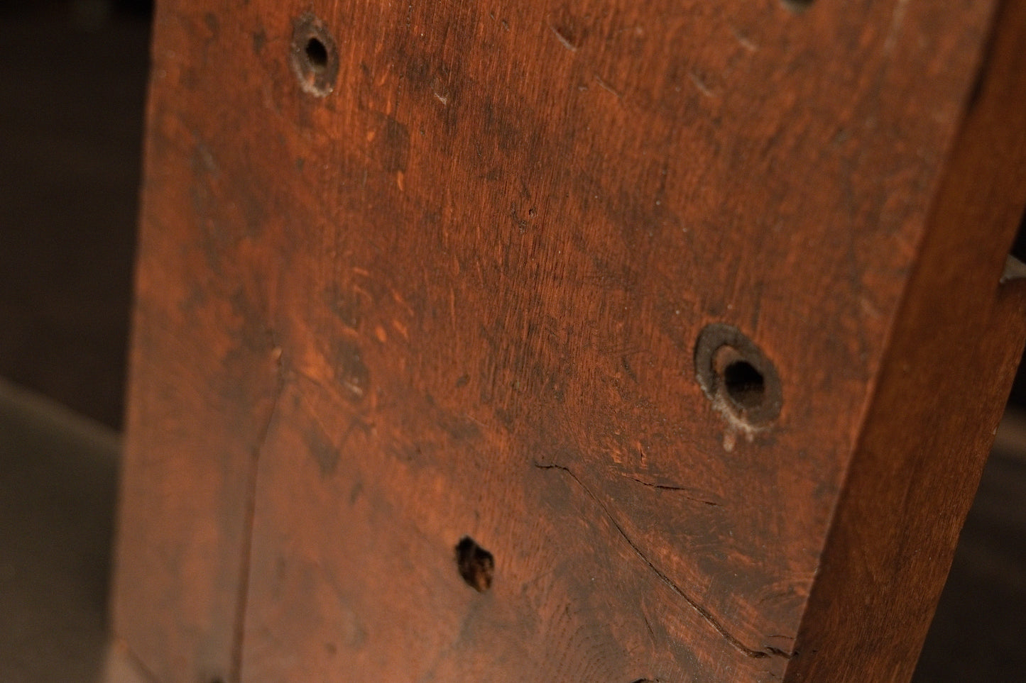 Detailed view of the epoxy-free wooden surface showing authentic entomological character and historical structural peg holes. 