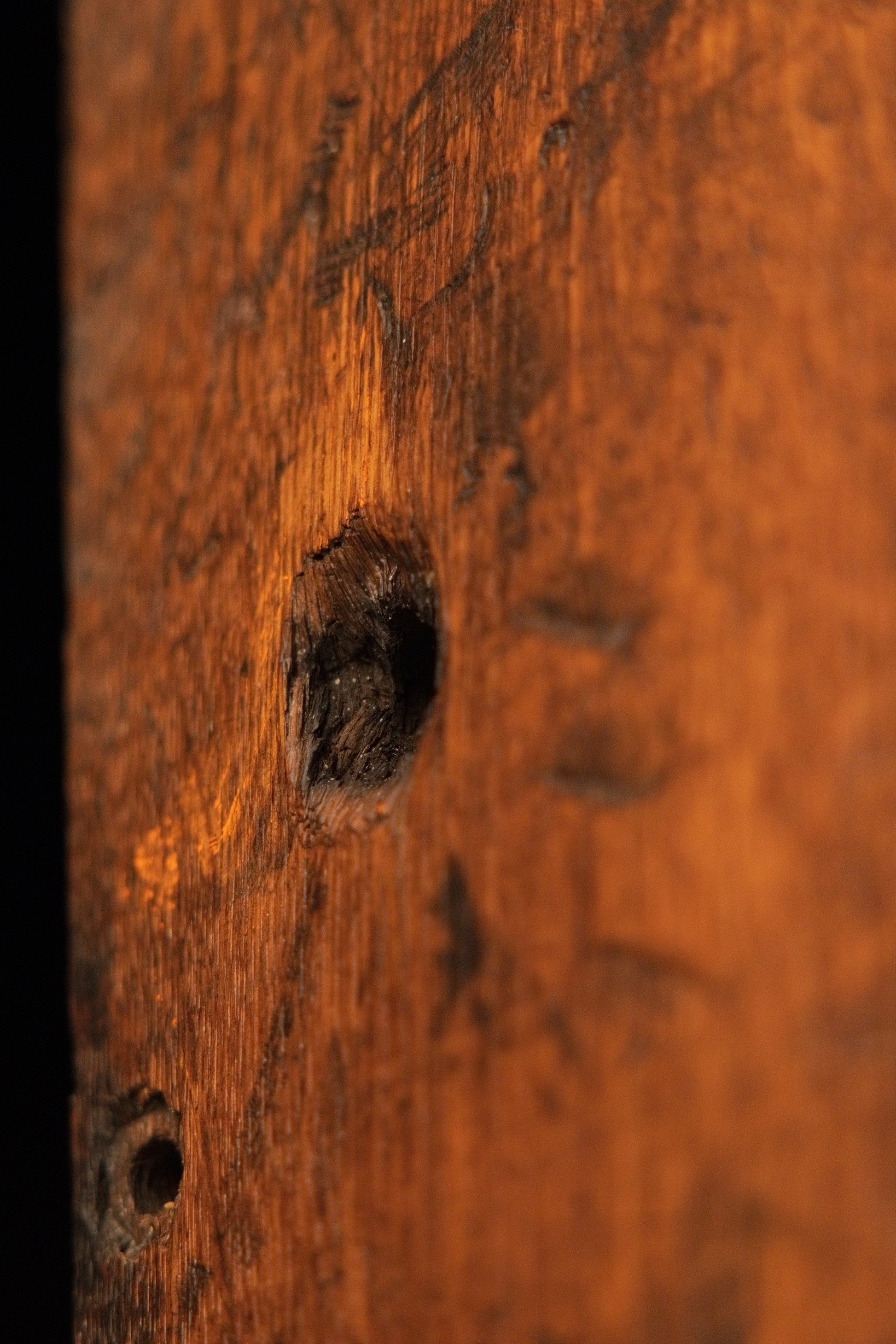 Close up of an authentic joinery void in the golden heritage oak block emphasizing raw structural integrity and biophilic form. 