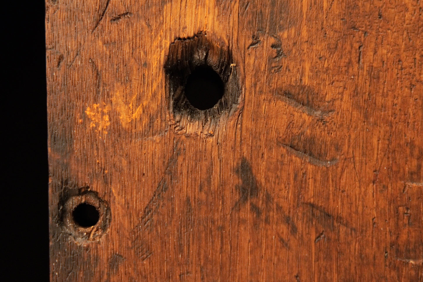 Macro detail of two historical peg holes and authentic surface scoring on the digital twin ready architectural structural wood. 