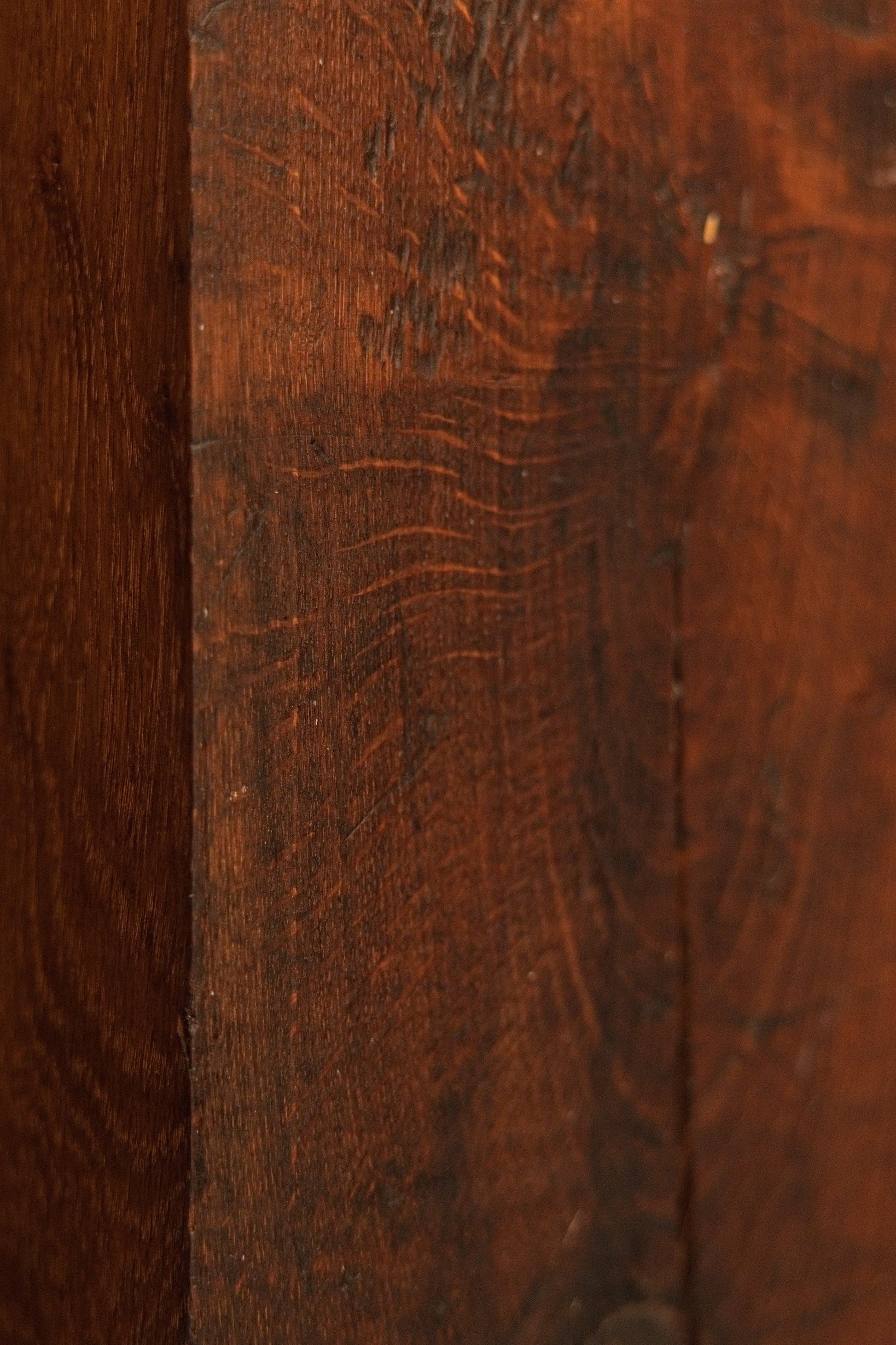Close detail of the vertical wood grain on the heritage structural element highlighting natural hygroscopic equilibrium marks. 