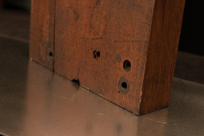 Lower front right angle of the golden architectural monolith showcasing floor-heating stable structure and historic peg voids. 