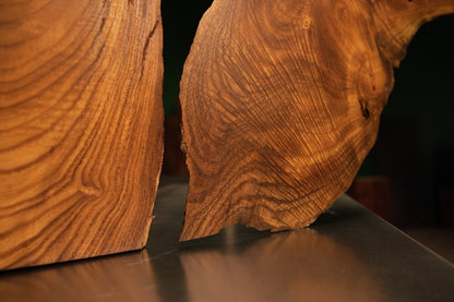 Close-up view focusing on the distinct central gap and vertical grain textures between the two halves of the medium oak sculpture.
