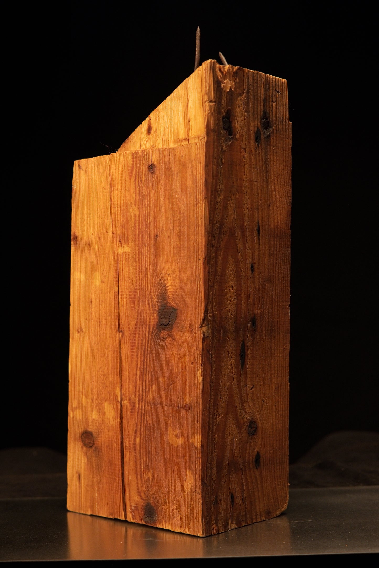 Full vertical profile of a Transylvanian architectural salvage beam displaying dense golden wood grain and authentic iron nails.   