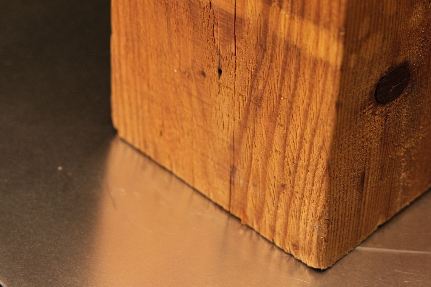 Angled base view of a fully stabilized historic structural beam displaying authentic surface scoring and pristine wooden texture.   