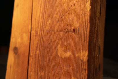 Macro detail of historical tool marks and authentic surface scoring on a piece of century-old Transylvanian architectural salvage.   