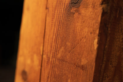 Angled macro perspective of tight vertical grain patterns on a solid botanical heritage piece highlighting true original patina.   