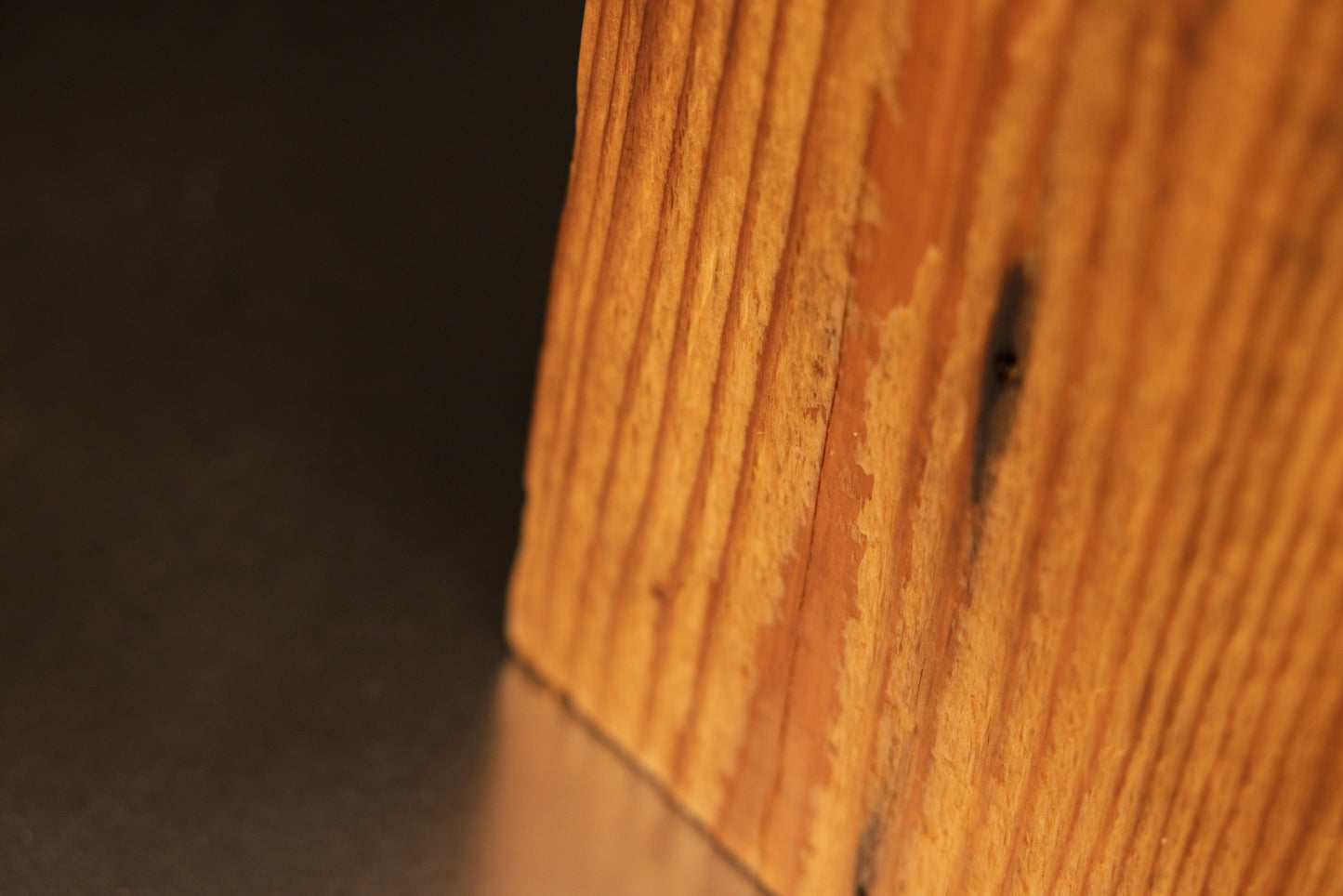 Extreme close-up of the perfectly stabilized architectural wood corner displaying hygroscopic equilibrium and precise texture.   