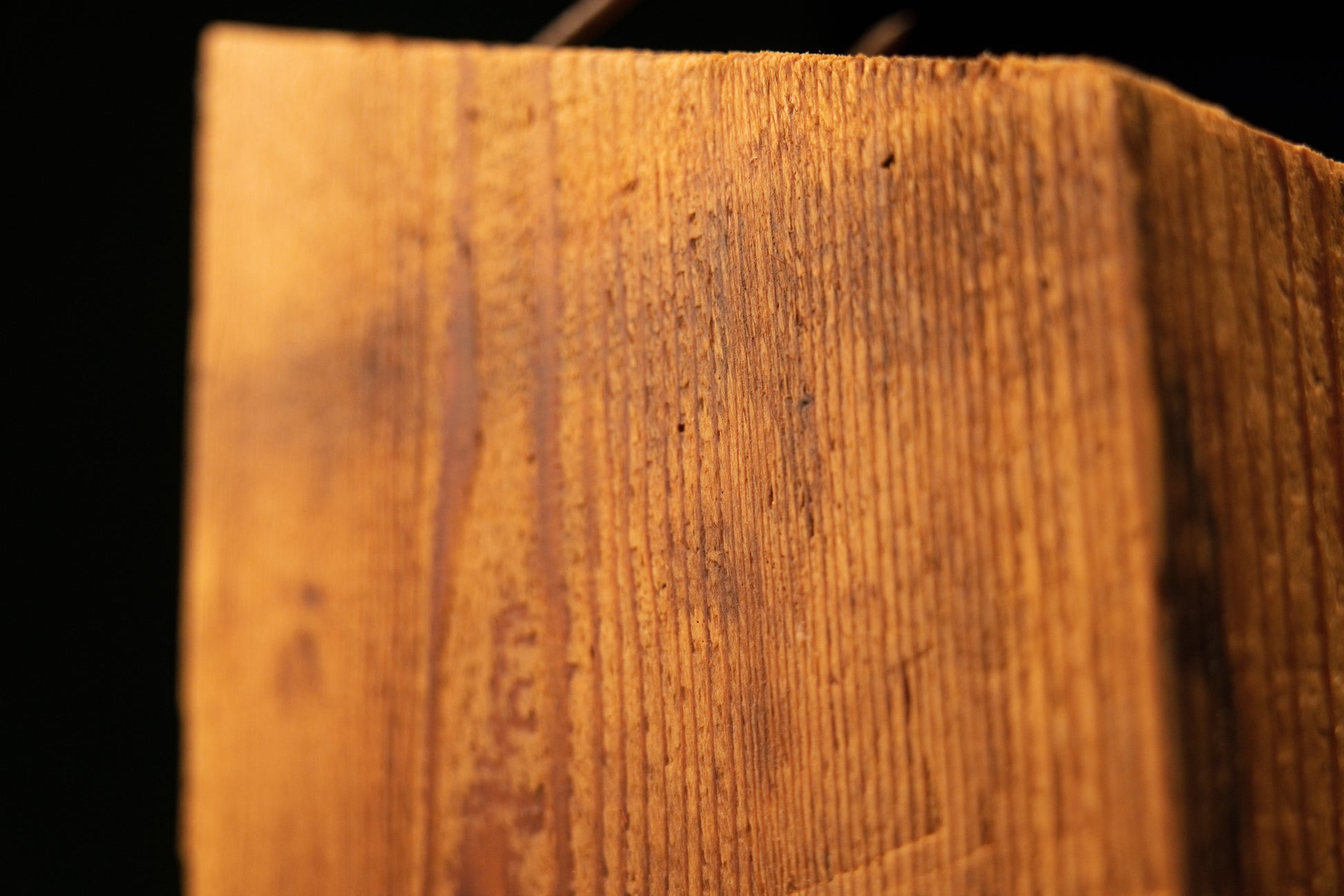 Detailed corner perspective of a historic Transylvanian salvage timber showing deep cellular stabilization and natural patina.   