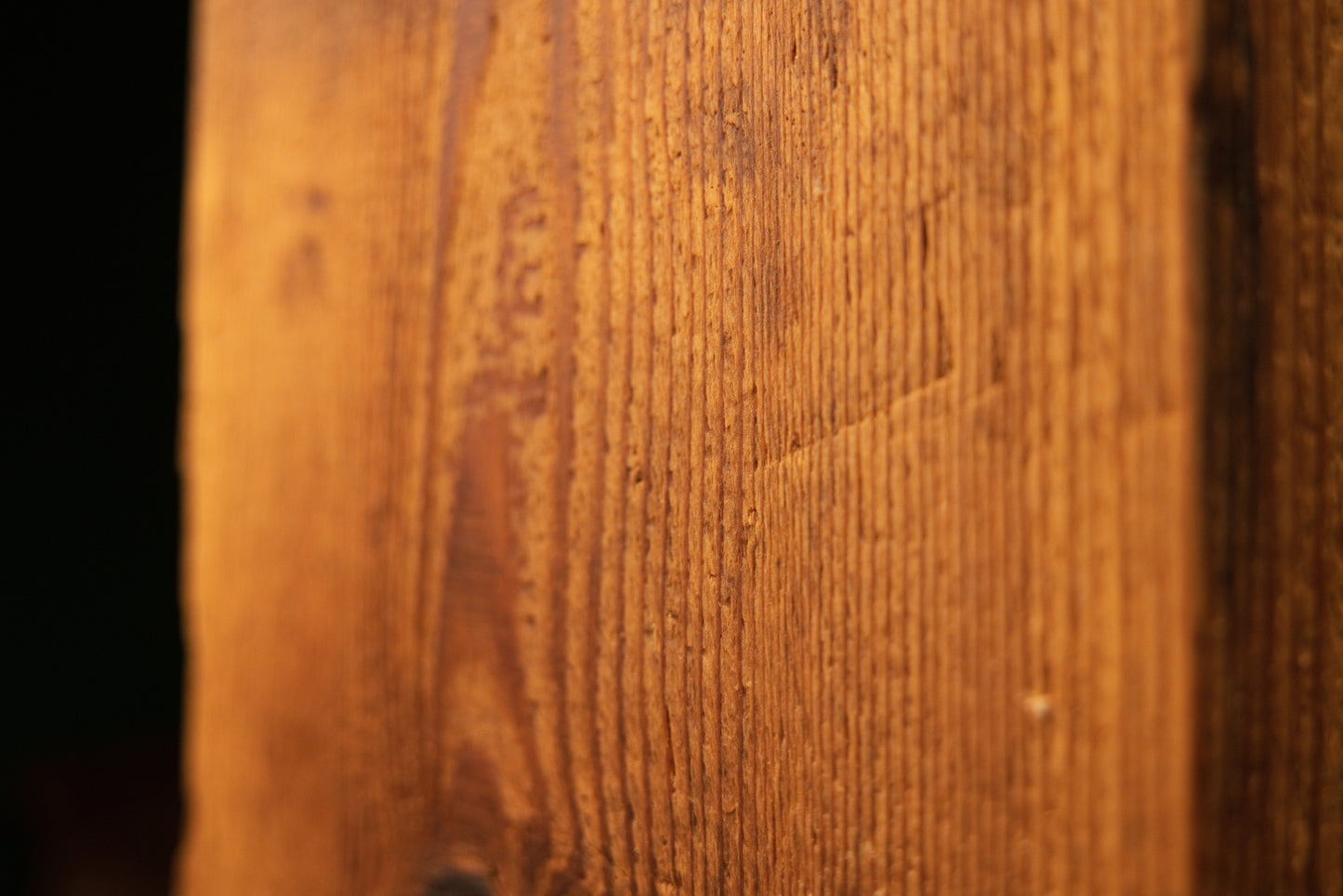 Close-up of natural surface texture variance and dense vertical grain lines on a fully stabilized commercial timber structural.   
