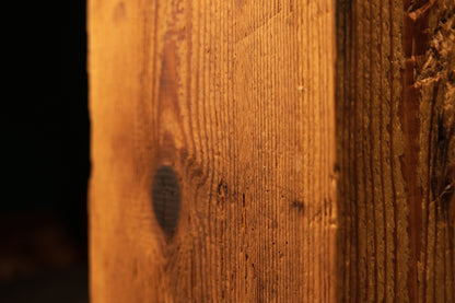Close-up focus on a circular dark joinery void in a museum-grade architectural beam showcasing zero maintenance liability.   