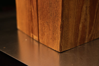 Lower corner view where the stabilized historic wooden monolith meets the surface demonstrating absolute dimensional stability.   