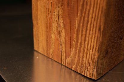 Macro focus on the perfectly flat base corner of a Relic-Grade botanical wood element emphasizing true architectural mass.   