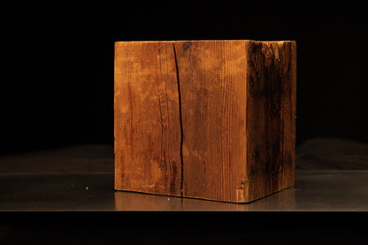 Front angled view of a square relic-grade structural timber block featuring a deep vertical face crack and dark oxidized side.[cite: 1, 3]