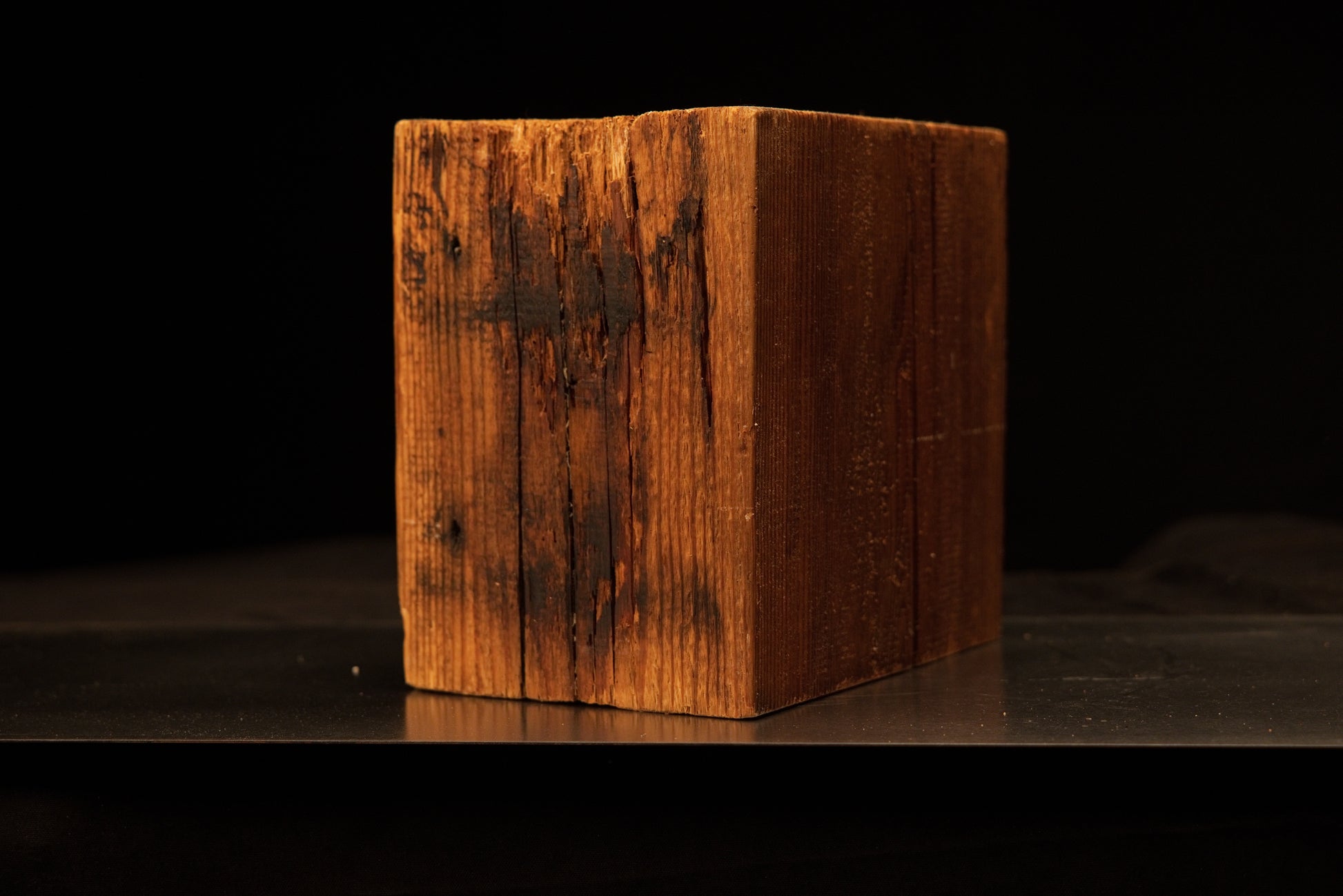 Upper corner detail of a botanical monolith highlighting the contrast between golden grain and dark true patina.[cite: 1, 3]