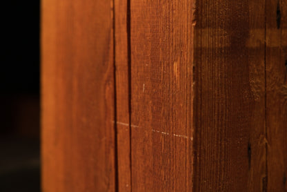 Extreme close-up of a stabilized vertical wood check inside a thick-cut structural timber slab showing raw botanical textures.[cite: 1, 3]