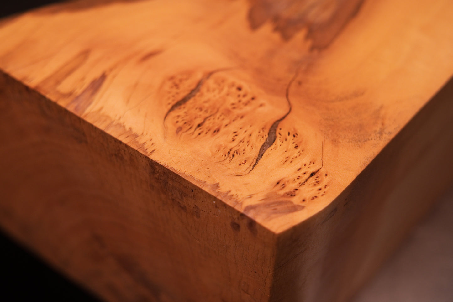 Close detail on the smooth upper surface of a biophilic architectural element displaying authentic grain and stabilized checks.   