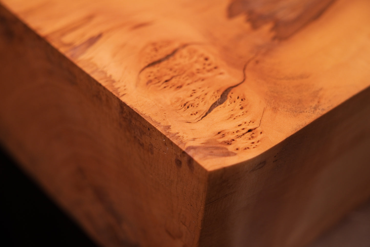Detailed focus on the pristine polished flat face of a biophilic structural element displaying bright vertical grain patterns.   