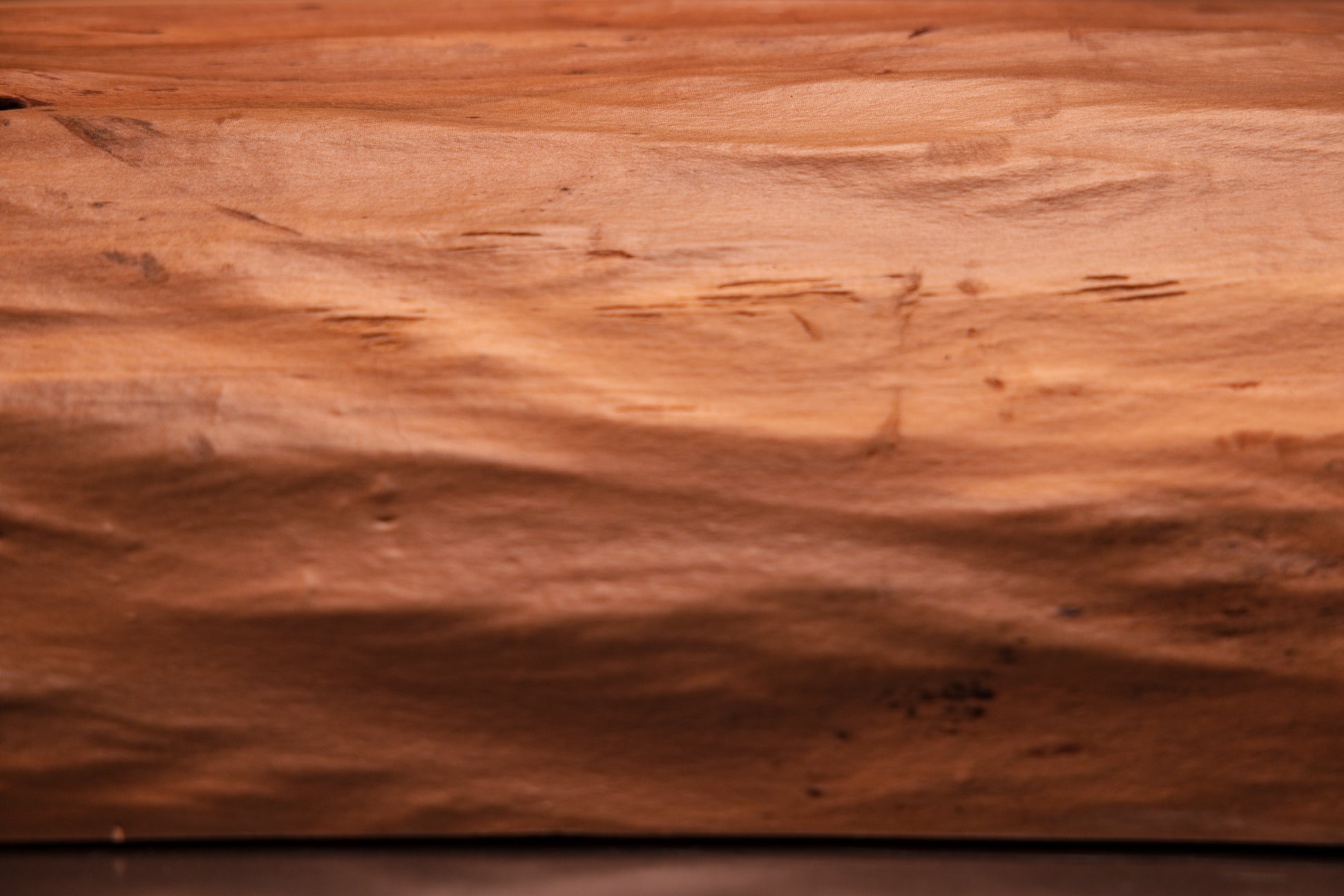 Side profile of a tall structural timber block showcasing a smooth tapered edge and climate-stable organic wooden geometries.   
