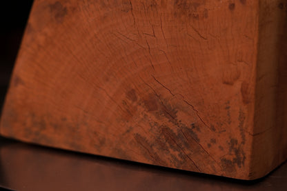 Macro photography of a museum-grade architectural wood surface showcasing wavy golden grain and unique biological pigmentations.   