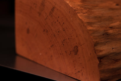 Close-up of the precise edge transition on a structural wooden element revealing dense botanical wood grain.   