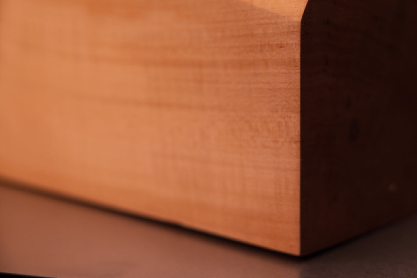 Horizontal macro perspective of a polished botanical heritage slab highlighting smooth dimensional stability and flowing grain.   