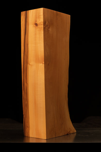 Detailed view of the polished architectural wood face featuring distinct dark biological pigmentations and flawless texture.   