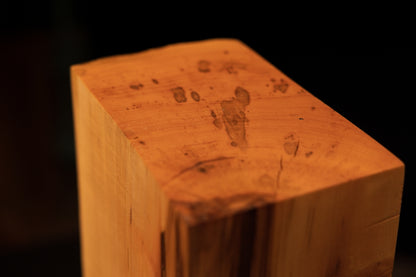 Top corner macro highlighting authentic insect engraving and small botanical voids on the wavy edge of the heritage timber.   