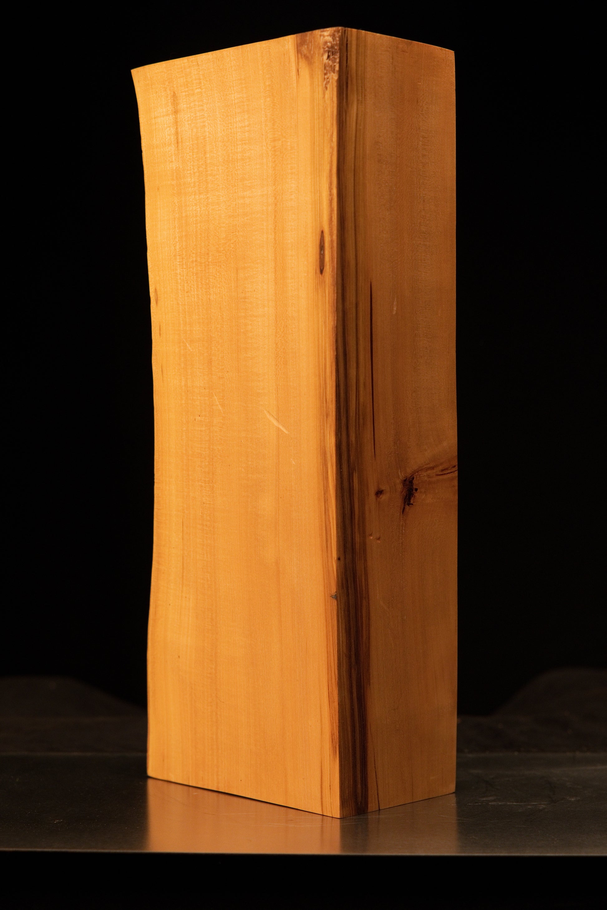 Top corner perspective of a biophilic structural wood block displaying absolute organic dimensional stability.   