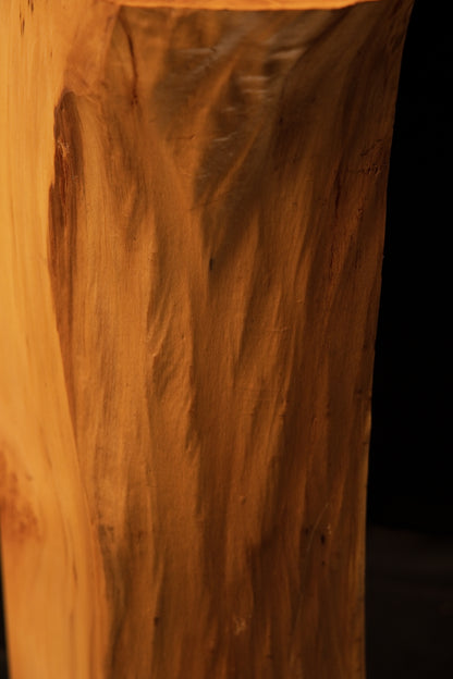 Close-up of the smooth flat face on a museum-grade architectural wood piece revealing deep sweeping dark grain pigmentations.   