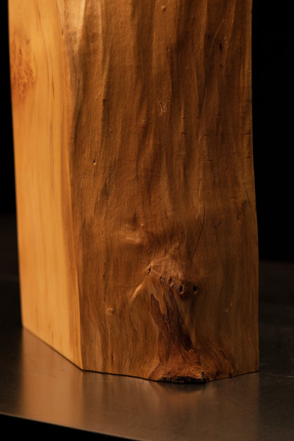 Full standing profile of a climate-stable structural wooden block showcasing a smooth flat face and a flowing botanical edge.   