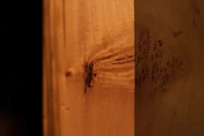 Close detail of flowing vertical grain lines and unreplicable chaotic geometries on a fully stabilized architectural wood face.   