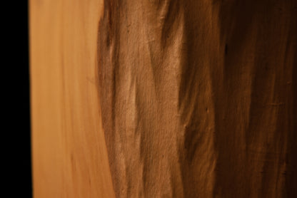 Extreme close-up of a small structural knot and stabilized horizontal check inside an epoxy-free architectural timber element.   