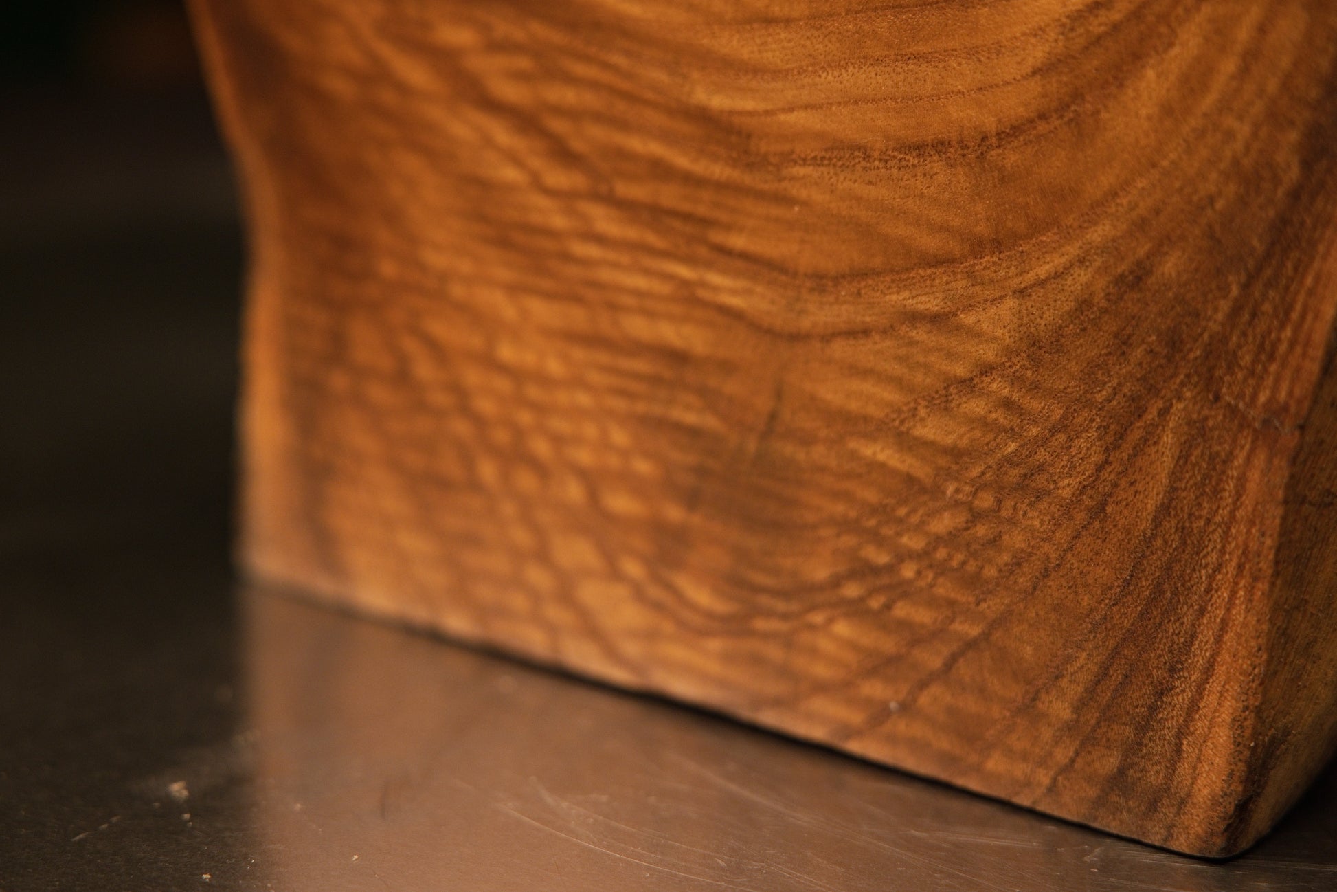 Back corner angle of a heavy botanical display highlighting smooth flowing lines against a darkened upper border profile.   