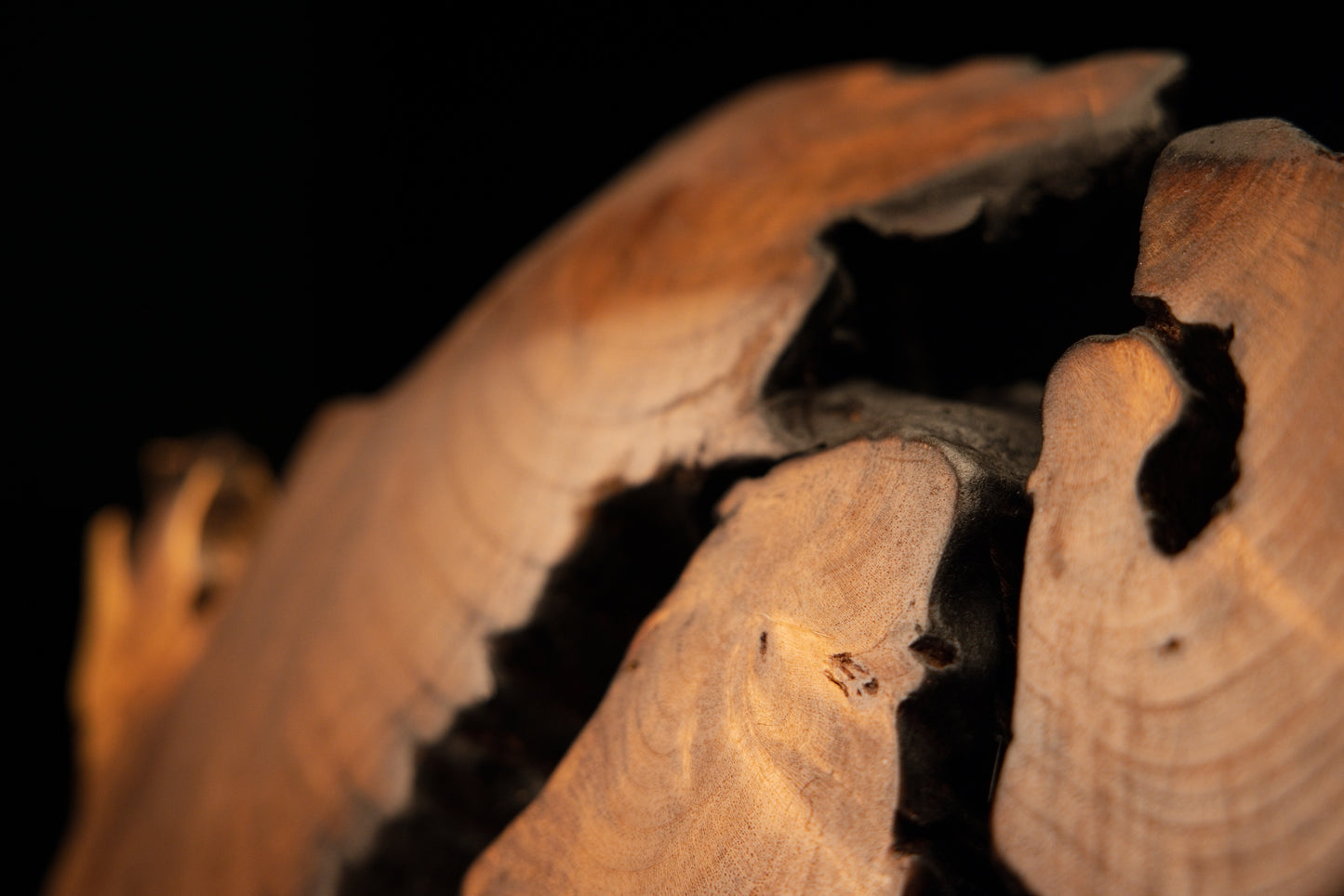 Macro detail of the lower perimeter showing a flat, perfectly level structural resting edge on the heavy timber art piece.   