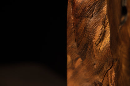 Macro view of undulating golden-brown timber fibers highlighting long-term dimensional stability and smooth hand-rubbing.   