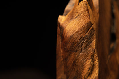 Lower corner framing showing sweeping golden grain sloping downward to meet the pristine flat foundation of the art block.   
