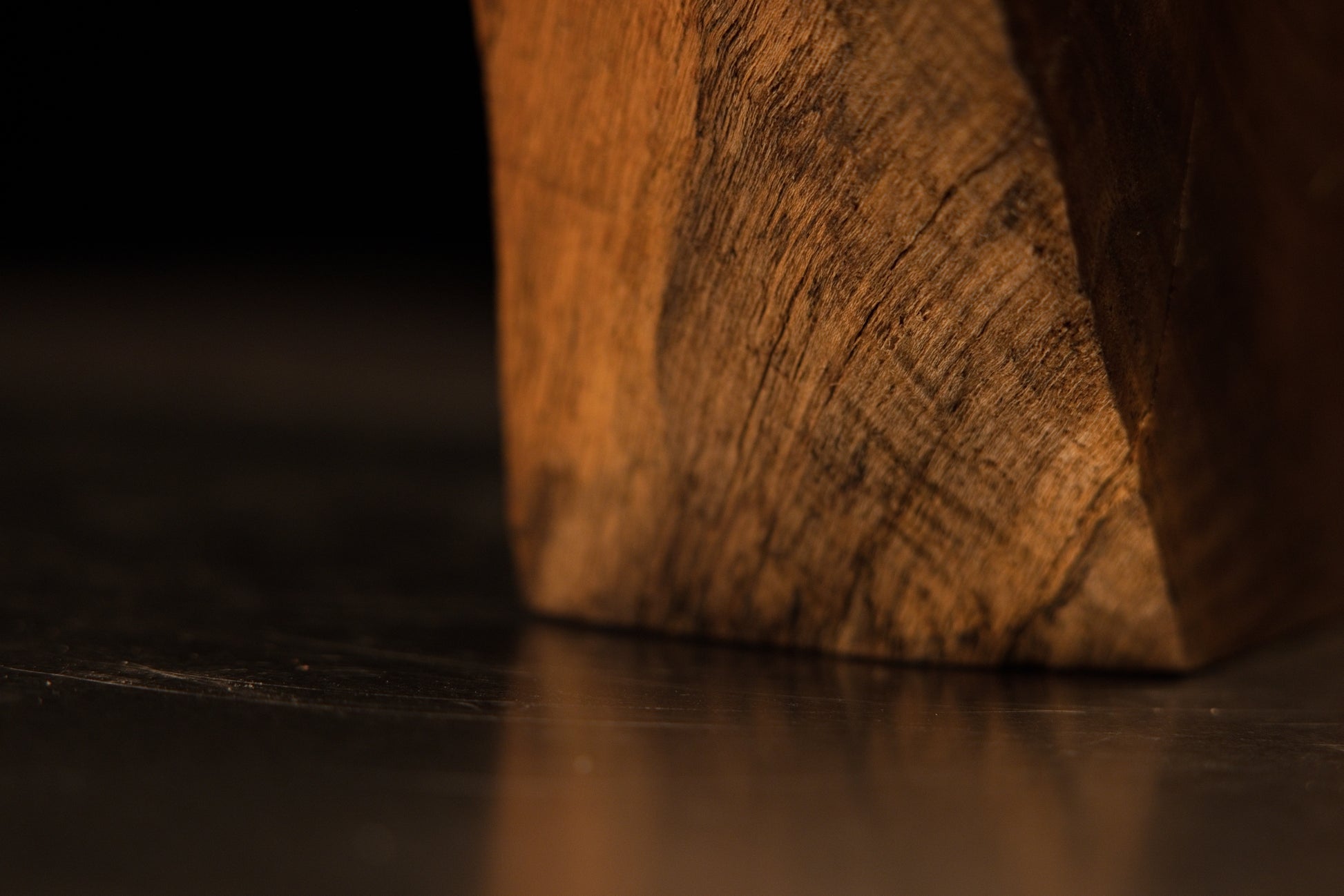Vertical framing of rich golden wood fibers intersected by a small, perfectly stabilized hairline surface check.   
