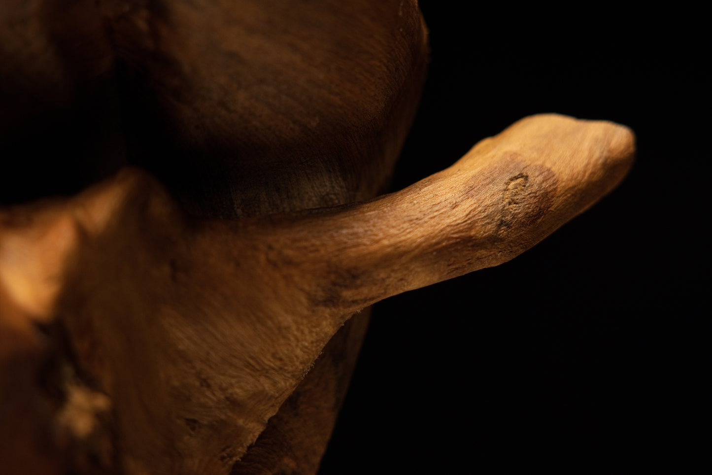 Detailed macro of rough organic surface textures along the lower corner edge, emphasizing the massive weight of the art piece.   