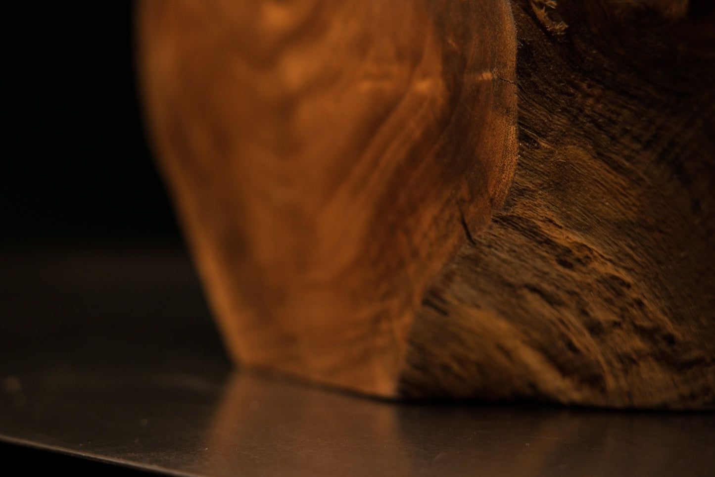 Slim side profile view emphasizing dense vertical grain architecture and a dark geometric angle cut at the top.   