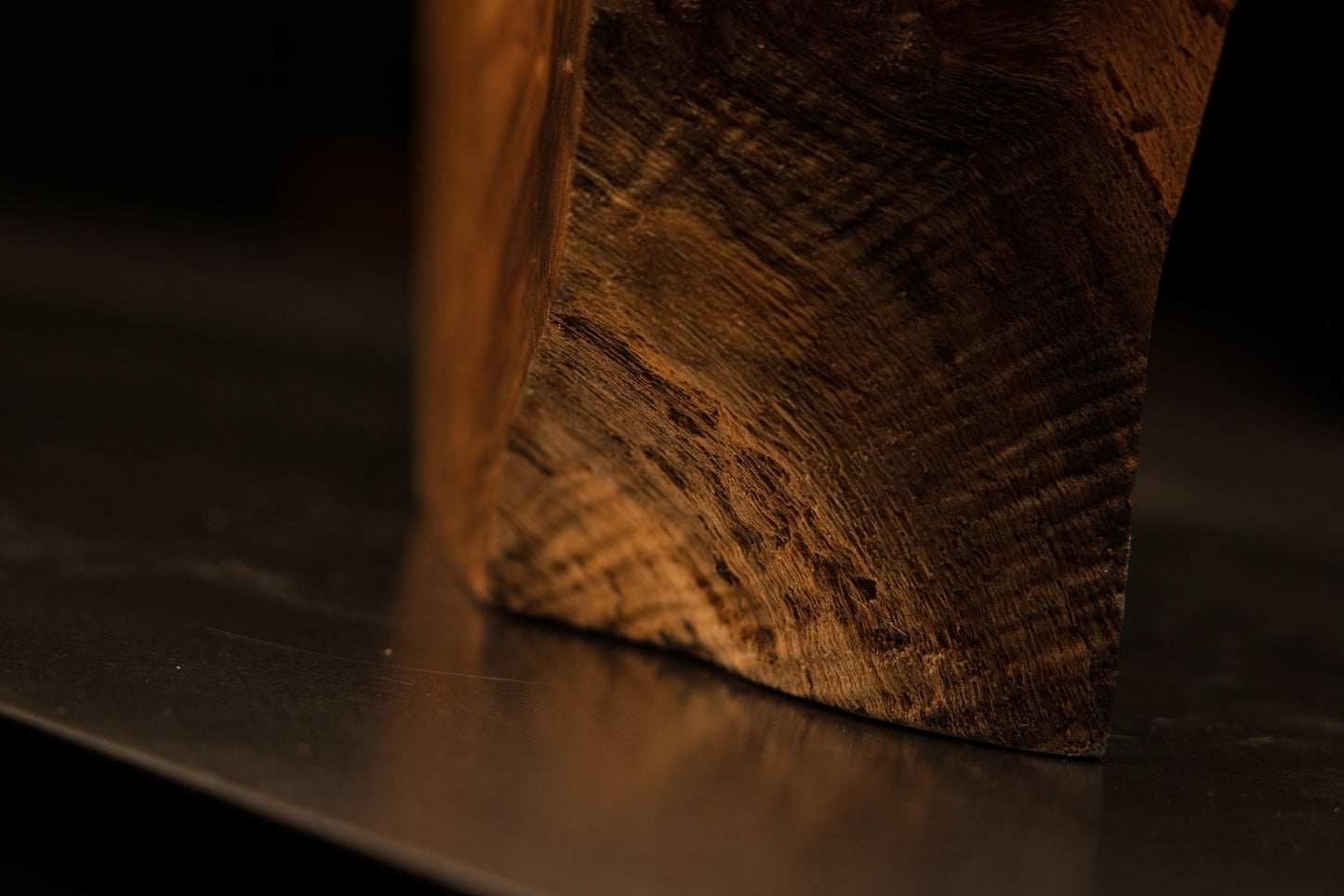 Angled perspective of an uneven top boundary blending effortlessly into sweeping lateral grain on a gallery-grade art piece.   