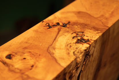 Close-up study of the upper precision-cut flat surface on a fully stabilized commercial timber block revealing hidden dark voids.   