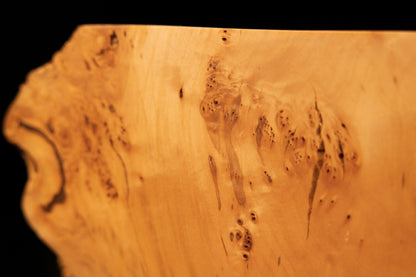 Close-up detail featuring a chaotic burl cluster embedded deeply inside the smooth polished face of an advanced epoxy-free art slab.   