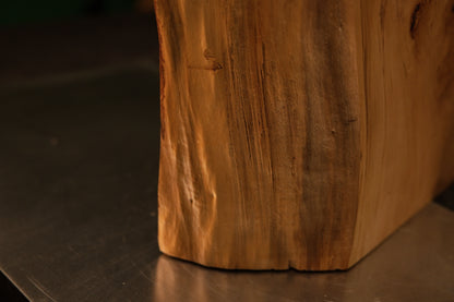 Detailed lower corner framing showing dense vertical wood fibers uniting seamlessly with a precise flat baseline foundation cut.   