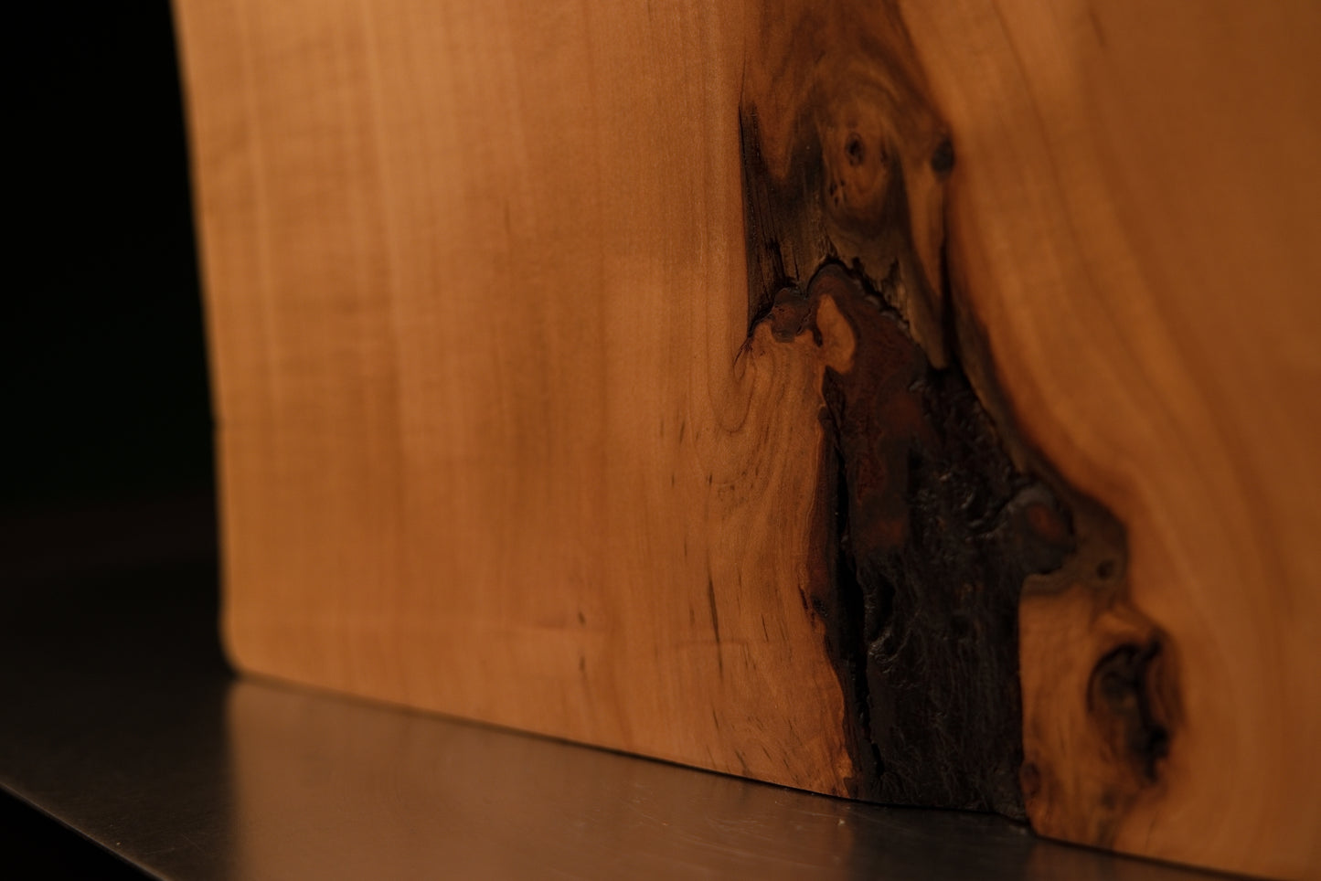 Macro detail of a deep organic wood crevice contrasting with smooth golden grain on an epoxy-free historic architectural block.   