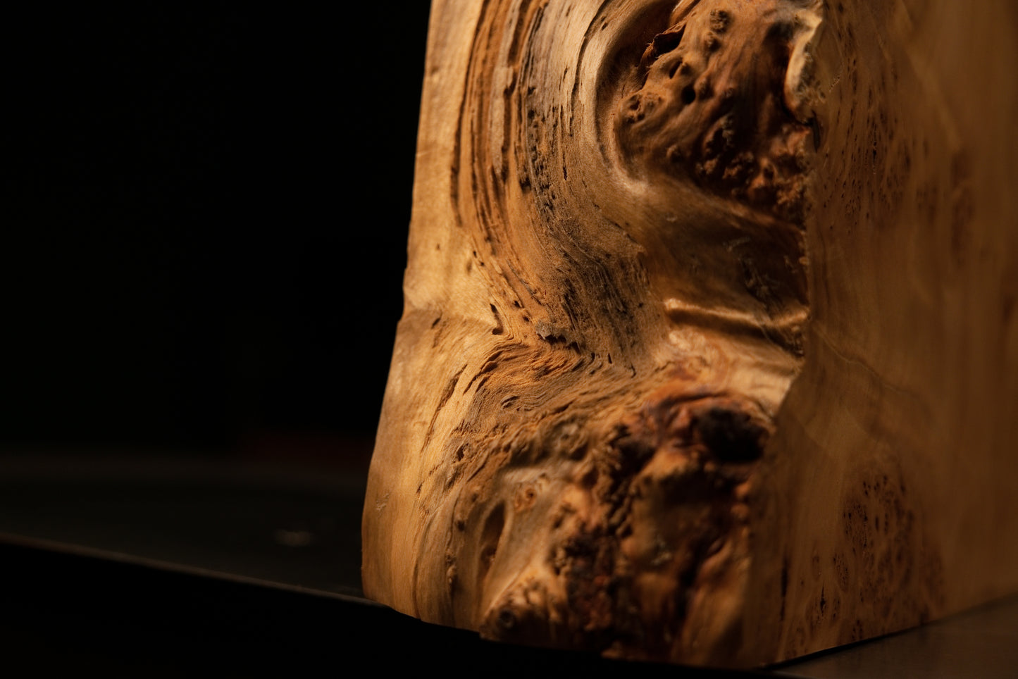 Extreme macro of sweeping wood fibers swirling around a dense botanical burl cluster on a floor-heating compatible interior piece.   