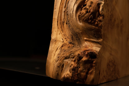 Extreme macro of sweeping wood fibers swirling around a dense botanical burl cluster on a floor-heating compatible interior piece.   