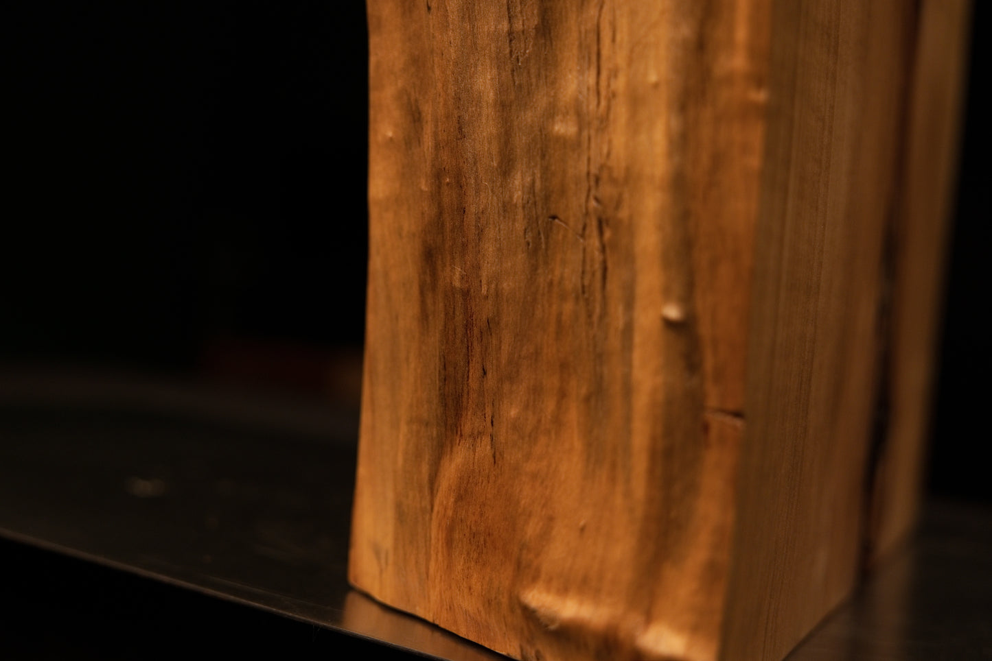 Base section close-up highlighting dense vertical wood grain terminating at the precision flat cut of a climate-stable timber block.   