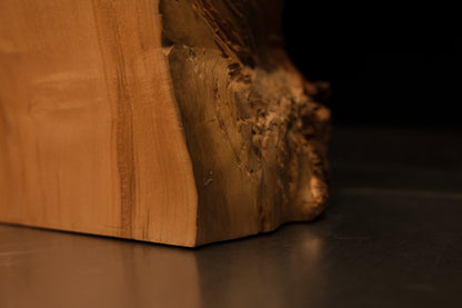Angled macro capturing the exact edge where a flawless architectural cut meets the deep organic crevices of a resin-free wood block.   