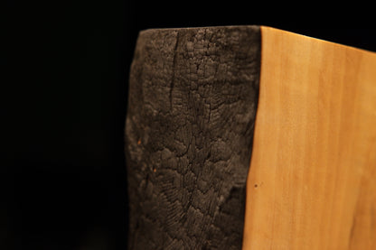 Angled macro of the upper charred edge transitioning into a smooth precision cut top on a completely resin-free wood slab.    